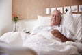 Male Senior Patient Lying In Hospital Bed Watching Television Royalty Free Stock Photo