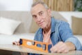 male senior during wood measuring with spirit level Royalty Free Stock Photo