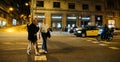 Male seniors crossing street at night in Barcelona