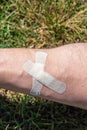 male shin wound sealed by adhesive plaster close up Royalty Free Stock Photo