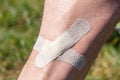 male shin wound sealed by adhesive plaster close up Royalty Free Stock Photo