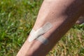 male shin wound sealed by adhesive plaster close up Royalty Free Stock Photo