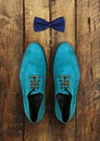 Male shoes and bow-tie on a brown wooden Royalty Free Stock Photo