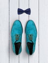 Male shoes and bow-tie on a white wooden background Royalty Free Stock Photo