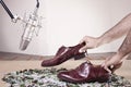 Caucassian male hands with male dress shoes moving on broken glass and near to a studio mic on Full Color Version