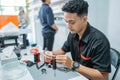 male shopkeeper changing the vape cotton coil seriousely