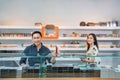 male shopkeeper standing put the vape mod on the display table