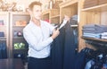 Male shopper choosing new suit in male shop Royalty Free Stock Photo