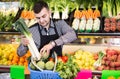 Male shopping assistant helping to buy fruit and vegetables in grocery shop Royalty Free Stock Photo