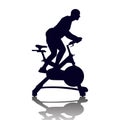 Male silhouette on exercycle in spinning class Royalty Free Stock Photo