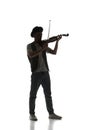 Male silhouette, musician playing violin isolated on white background. Black and white image. Royalty Free Stock Photo