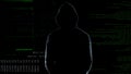 Male silhouette standing against numbers codes after committing cyber crime