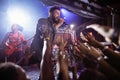 Male singer performing on stage by crowd at nightclub Royalty Free Stock Photo