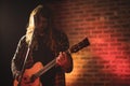 Male singer practicing with guitar in nightclub Royalty Free Stock Photo