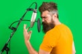 Male singer in recording studio. Bearded man sing in microphone. Karaoke. Studio records. Sings a song. Royalty Free Stock Photo