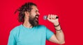 Male singing with microphone. Bearded man in karaoke. Emotional vocalist sing in studio. Music. Royalty Free Stock Photo