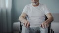 Male sitting in wheelchair, thinking about his life at rehabilitation center Royalty Free Stock Photo