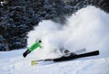 Male skier in bright outfit skiing downhill on fresh powder snow. Royalty Free Stock Photo