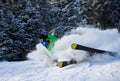 Male skier in bright outfit skiing downhill on fresh powder snow. Royalty Free Stock Photo