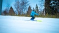 Male skier carving down the slope kicking up snow Royalty Free Stock Photo