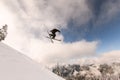 skier performs masterful jump in the air over snowy mountain slope