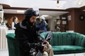 Male skier seated on sofa with snow gear