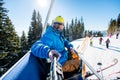 Male skier using selfie stick taking photos while skiing