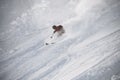 Skiier in full equipment rides on a ski in mountains