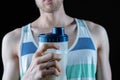 the male skinny sport man holding a shaker while workout