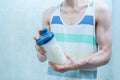 the male skinny sport man holding a shaker while workout