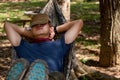 Male sleeping in hammock in camping in forest