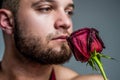 male smell flower. sexy man with bristle. gift with love. happy valentines day. gift from valentine. muscular man Royalty Free Stock Photo