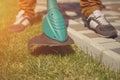 Male in sneakers and pants is cutting green grass with handheld modern lawn mower in his garden. Gardening care Royalty Free Stock Photo