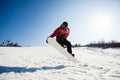 Male snowboarder in action jumping over hill Royalty Free Stock Photo