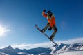 Male Snowboarder Catches Big Air on a Bright Sunny Day Royalty Free Stock Photo