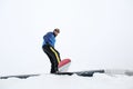 Male snowboarder doing trick at winter resort Royalty Free Stock Photo