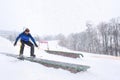 Male snowboarder doing trick at winter resort Royalty Free Stock Photo