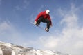 Male Snowboarder Jumping Against Cloudy Sky