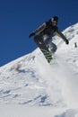 Male snowboarder ripping up the fresh powder