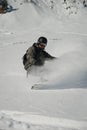 Male snowboarder ripping up the fresh powder