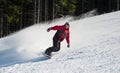 Male snowboarder slides down from the mountain