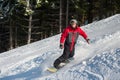 Male snowboarder slides down from the mountain