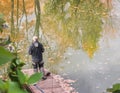 A male social worker ecologist watches the state of the water in the city pond, standing on the Bank. Environmental monitoring of