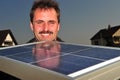 Male solar worker install solar panels on home