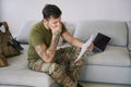 Army combatant at home reading bad news from document