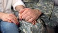 Male soldier holding girlfriends hand, farewell before military service, love Royalty Free Stock Photo