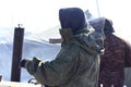 A male soldier holds an axe on his shoulder