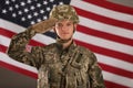 Male soldier saluting against flag. Military service Royalty Free Stock Photo