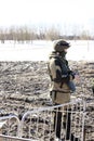 A male soldier stands in a field