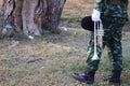 Male soldiers standing holding musical instruments Lawn background